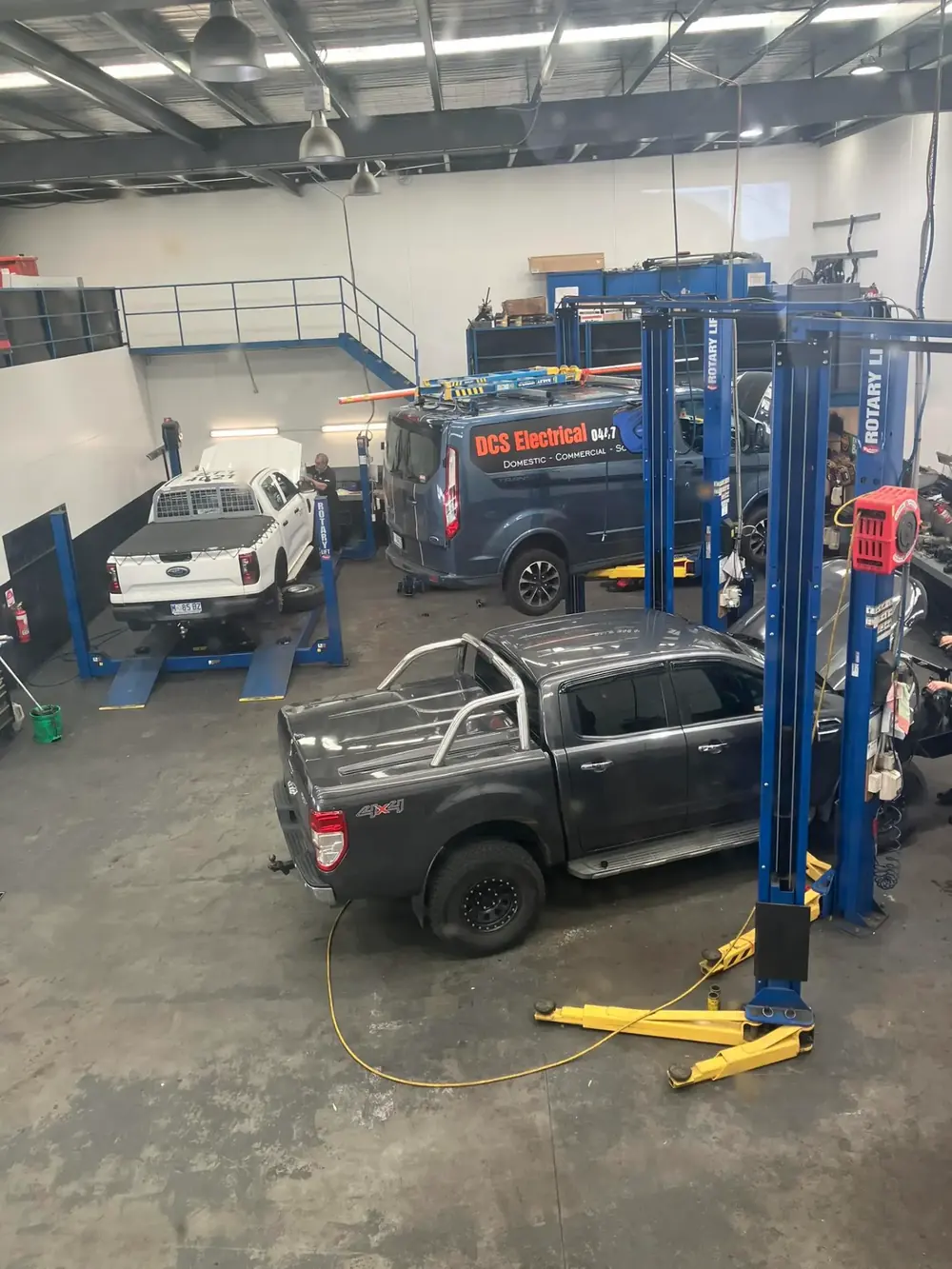 Vehicles and equipment inside the Howell Automotive service bay